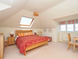 A bedroom with a bed and furniture at Cartway Cove, Port Isaac