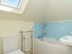 A bathroom with a bathtub and sink at Cartway Cove, Port Isaac