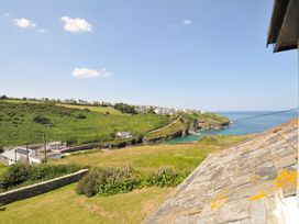 A scenic view of the coast and hills at Cartway Cove, Port Isaac