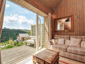 A living room with a sofa and coffee table at Cartway Cabin Port Isaac