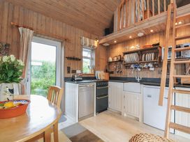 A kitchen with a table and chairs at Cartway Cabin in Port Isaac