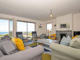 A living room with a coffee table and armchairs at Upper Gren in Trebetherick