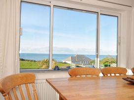 A dining room with a view of the sea at Upper Gren in Trebetherick