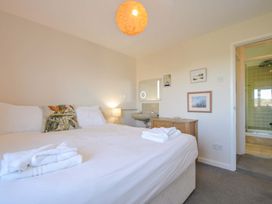 A bedroom with a bed and attached bathroom at Upper Gren in Trebetherick