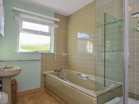 A bathroom with a bathtub and sink at Upper Gren in Trebetherick