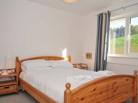 A bedroom with a bed and bedside lamps at Upper Gren in Trebetherick