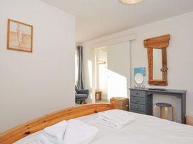 A bedroom with a bed and a desk at Upper Gren in Trebetherick