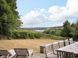 A garden with deck chairs and a dining table at The Old Granary in Rock