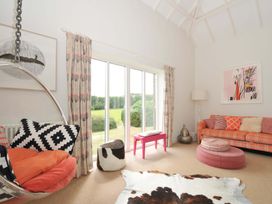 A living room with a hanging chair and sofa at The Old Granary in Rock