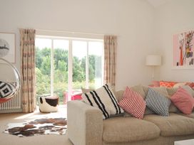 A living room with a sofa and cushions at The Old Granary in Rock