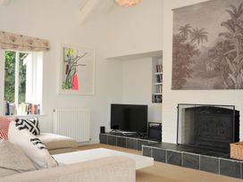 A living room with a sofa and television at The Old Granary in Rock