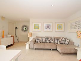 A living room with a sofa and wall art at The Old Granary in Rock