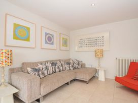 A living room with a sofa and artwork at The Old Granary in Rock