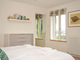 A bedroom with a bed and books on a shelf at The Old Granary in Rock