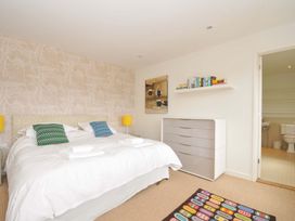 A bedroom with a bed and dresser at The Old Granary in Rock