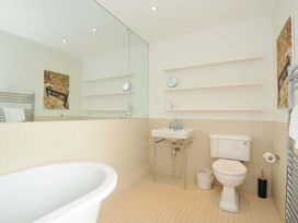 A bathroom with a bathtub, toilet, and sink at The Old Granary in Rock