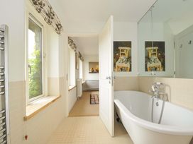 A bathroom with a bathtub and sink at The Old Granary in Rock