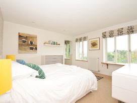 A bedroom with a bed and bookshelf at The Old Granary in Rock