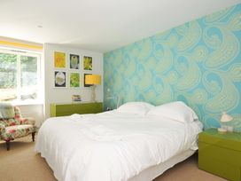 A bedroom with a bed and wall art at The Old Granary in Rock