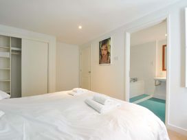 A bedroom with a bed and towels at The Old Granary in Rock