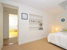 A bedroom with bed and bookshelf at The Old Granary in Rock