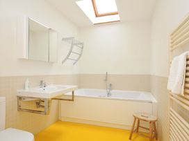 A bathroom with a bathtub and sink at The Old Granary in Rock