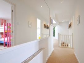 A hallway with a mirror and stairs at The Old Granary in Rock