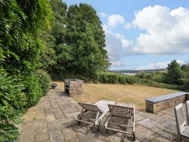 An outdoor area with a patio and grill at The Old Granary in Rock