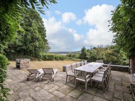 An outdoor dining area with a table and chairs at The Old Granary in Rock