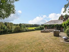 A garden with a patio and table at The Old Granary in Rock