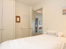 A bedroom with a bed and mirror at The Point in Polzeath