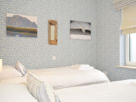 A bedroom with two beds and wall decorations at The Point in Polzeath