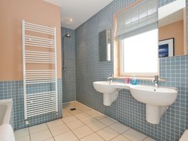 A bathroom with two sinks and a shower at The Point in Polzeath