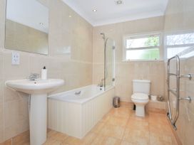 A bathroom with a bathtub shower sink toilet mirror and towel rack at Lowenna Manor 3 in Rock