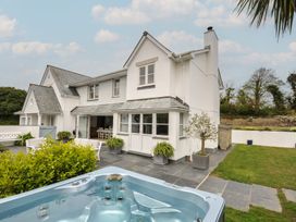 A house with a hot tub and patio area at Cherrytrees in Rock