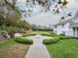 A garden with flowers, a bench, and a pathway at Cherrytrees in Rock