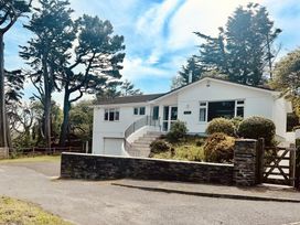 A house with a garage and steps at Beaches in Polzeath