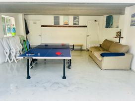A games room with a ping pong table and a sofa at Beaches in Polzeath