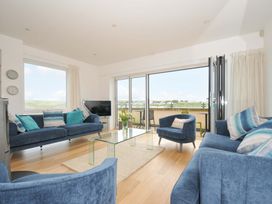 A living room with a sofa and coffee table at Stepper Point in Polzeath