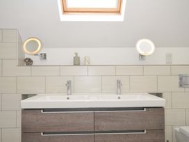 A bathroom with a sink and mirror in Stepper Point Polzeath