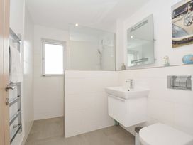 A bathroom with a shower, washbasin and toilet at Stepper Point in Polzeath