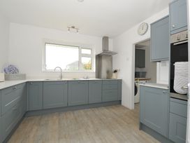 A kitchen with cabinets and a sink at Corriana in Rock