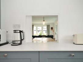 A kitchen with an opening to a living room at Corriana in Rock