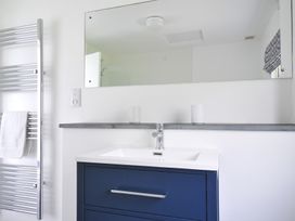 A bathroom with a wash basin and towel rack at Corriana in Rock