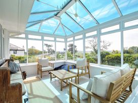 A conservatory with seating and table at Corriana in Rock