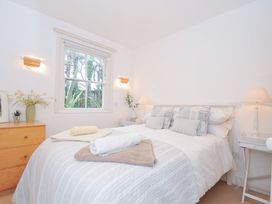 A bedroom with a bed and windows at Sandy Lodge Rock