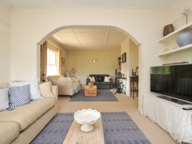 A living room with a sofa and a television at Sandy Lodge Rock