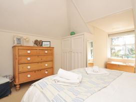 A bedroom with a bed and chest of drawers at Sandy Lodge Rock