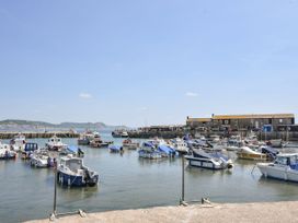 A harbor with boats and buildings at Coppingers Cottage in Polzeath