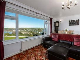 A living room with a view and furniture at Hillview in Polzeath
